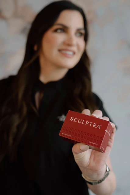 Woman holding a Sculptra cosmetic injectable box in Brookfield, WI | Luna Med Spa